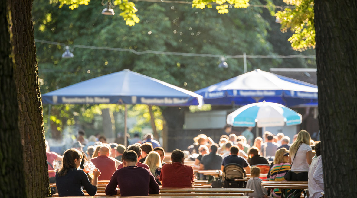 People sitting in a beer garden in the sun